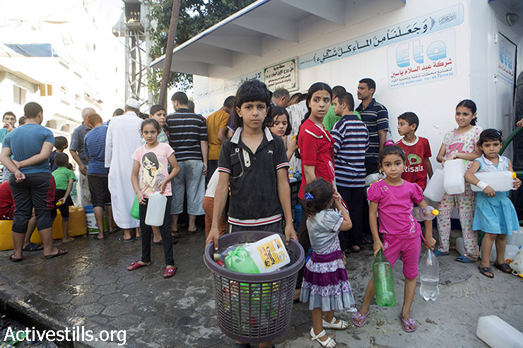 פלסטינים אוספים מים במחנה הפליטים שאטי בעזה, ה-2 באוגוסט, 2014. לפי דיווחי אוצ'ה, ל- 1.5 מיליון אנשים בעזה שאינם במקלטים יש גישה מאוד מוגבלת למים, אם בכלל. (באסל יאזורי / אקטיבסטילס)