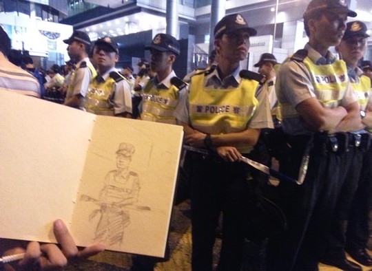 אחד המפגינים מצייר דיוקן של שוטר (צילום: אמנון לוטן)