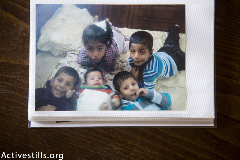 תמונת חמשת ילדי משפחת סיאם, מתוכם 4 נהרגו וניצל באדר (ימין תמונה), מצולמת בבית המשפחה ב 13 לנובמבר, 2014. 13 מחברי המשפחה נהרגו מפגיעל טיל ישראלי ב 21 ליולי, 2014, כאשר המשפחה ברחה ברחוב מן ההתקפות. באדר נפצע קשה ואביו שנותר בחיים איבד יד. (אן פאק / אקטיבסטילס)