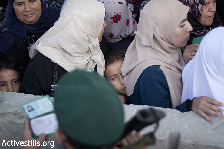 פלסטיניות חוצות את מחסום 300 שבין בית לחם וירושלים בדרכם לתפילה במסגד אל-אקצא בירושלים, ביום שישי השלישי של חודש הרמדאן, 3 ביולי, 2015. (מוסטפה באדר/אקטיבסטילס)