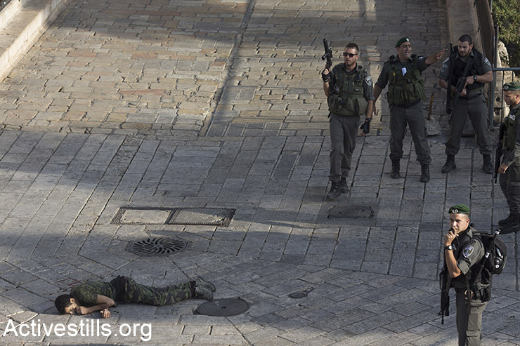כוחות ישראלים עומדים ליד גופת פלסטיני שנורה במהלך מה שתואר כאירוע דקירה, העיר העתיקה, ירושלים, 14 אוקטובר, 2015. (אקטיבסטילס)