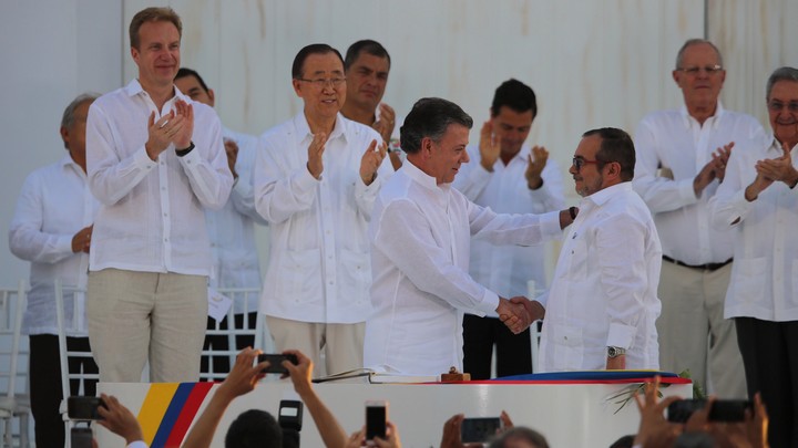 נשיא קולומביה, חואן מנואל סנטוס, ומנהיג FARC, רודריגו לונדוניו, חותמים על הסכם השלום שמסיים חמישים שנות מלחמה ביוני האחרון (PresidenciaRD CC BY-NC-ND 2.0)