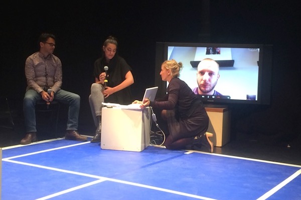 משמאל: הבמאי מיראז בזר והאוצרת מרי אל-קלקילי מדברים עם התסריטאי אמסעיל חלידי (על המסך) על ההצגה "טניס בשכם" (אנה-אסתר יונס)