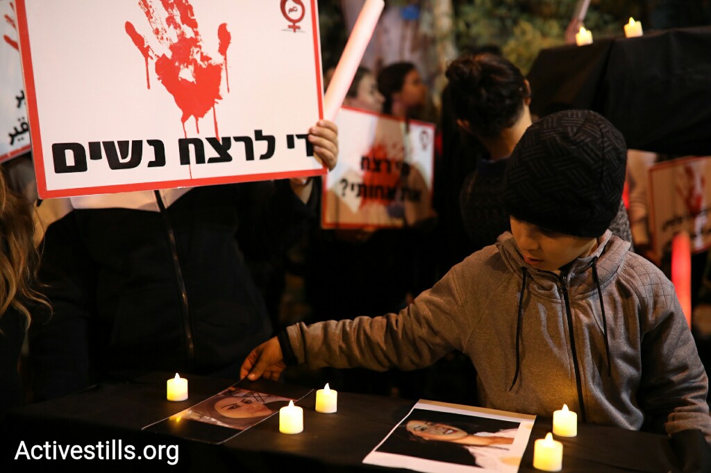 בנה של שאדיה מוסראתי מניח את תמונת אמו על הארון הסמלי בהפגנה (אורן זיו/ אקטיבסטילס)