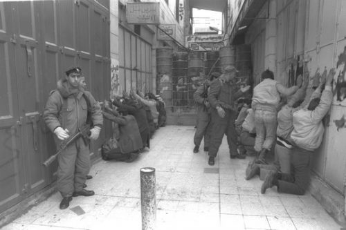 שוטרי מג"ב עוצרים פלסטינים בחברון. ינואר 1990. תמונת ארכיון מהאינתיפאדה הראשונה (צילום: נתן אלפרט/ לעמ)