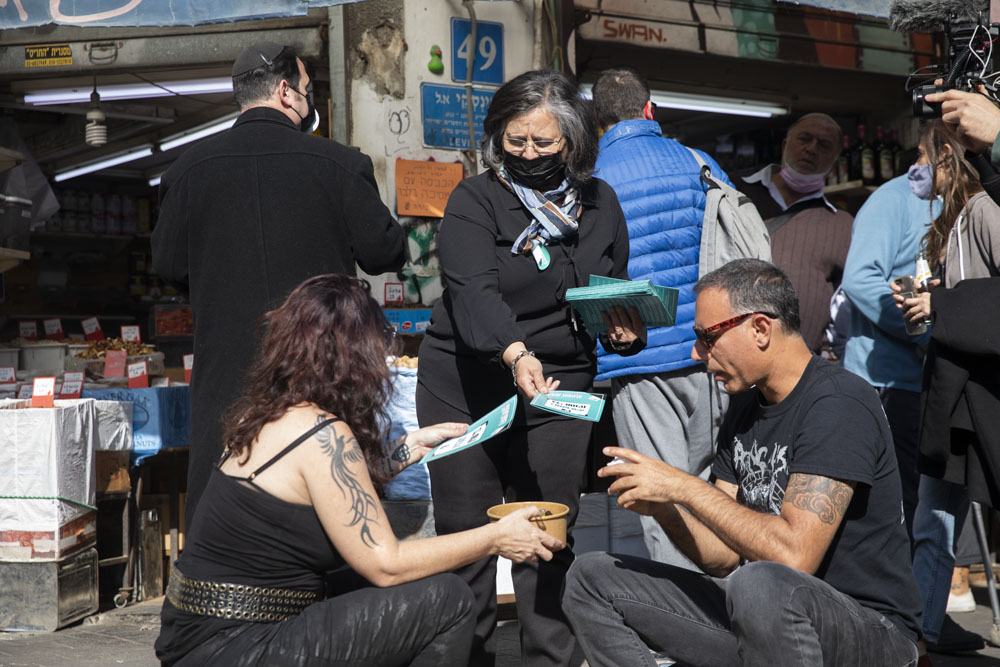 חברת הכנסת עאידה תומא סלימאן (הרשימה המשותפת) בסיור בחירות עם פעילי חד״ש בשוק לוינסקי בתל אביב, 25 בפברואר 2021 (צילום: אורן זיו)