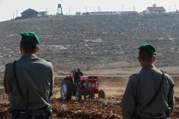רוב האדמות החקלאיות בגדה המערבית נמצאות בשטחי סי. חיילים משקיפים על חקלאי פלסטיני באזור כוסרא (צילום: נתי שוחט / פלאש 90)