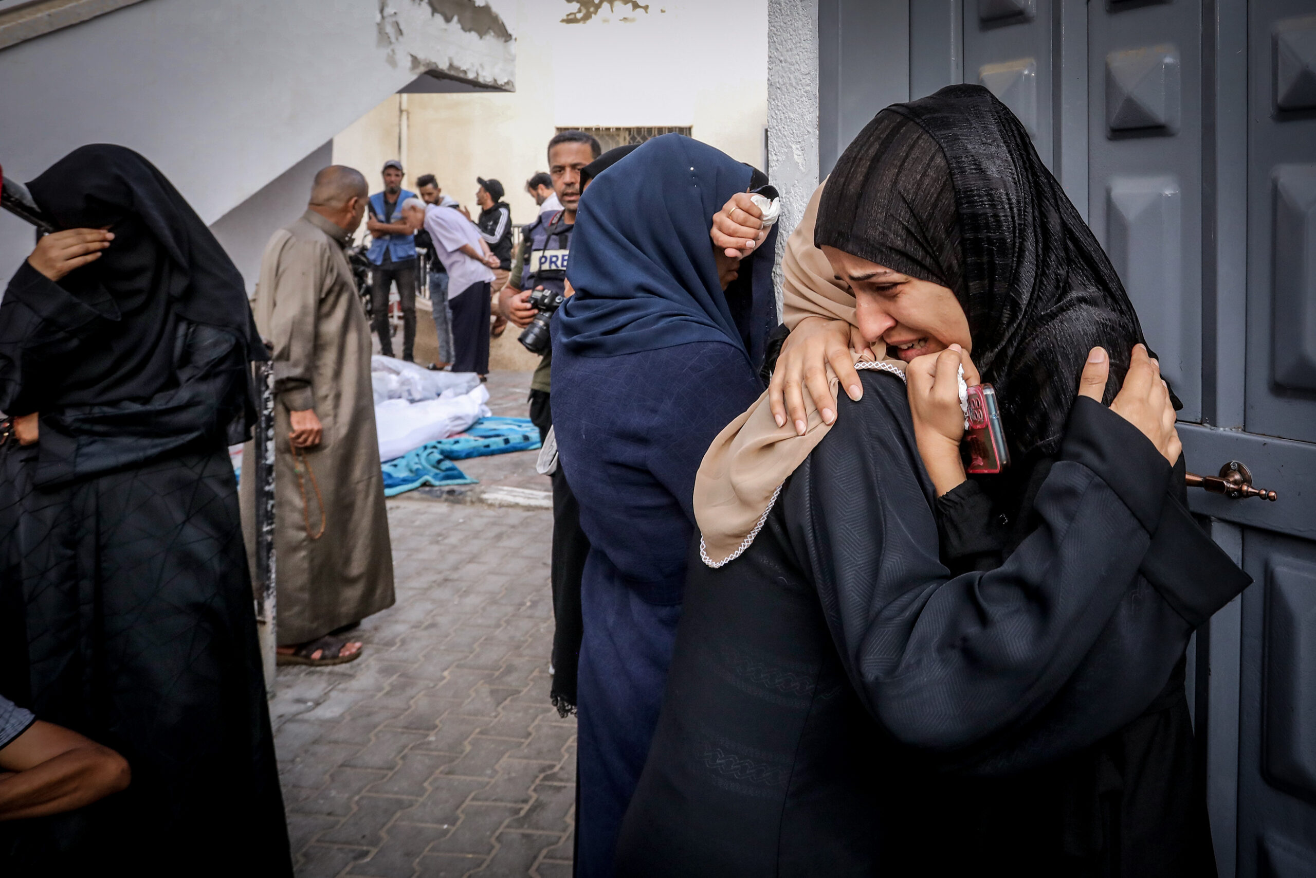 פלסטינים ממתינים לקבל את גופות יקיריהם, שנהרגו בהפצצה ישראלית, בבית החולים אל-נג'אר, בדרום רצועת עזה, ב-24 באוקטובר 2023 (צילום: עבד רחים ח'טיב / פלאש90)