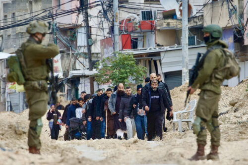 חיילים ישראלים מגרשים פלסטינים בדרך עפר שחוצה את מחנה הפליטים נור שמס, ב-10 בפברואר 2025 (צילום: והאג' בני מפלח)