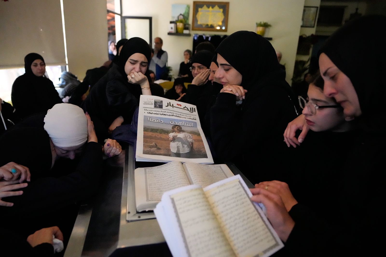 Mourners gather around the coffin of Lebanese journalist Amal Khalil who was killed on Wednesday in an Israeli airstrike, ahead of her funeral procession in the village of Baysariyeh, southern Lebanon, Thursday, April 23, 2026. (AP Photo/Mohammed Zaatari)